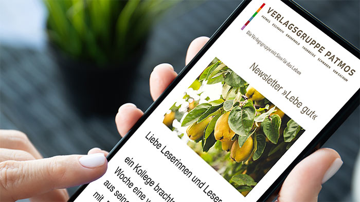 Frau liest einen Newsletter der Verlagsgruppe Patmos am Smartphone
